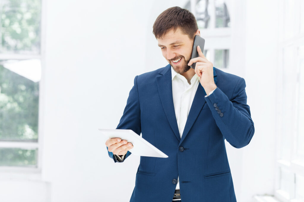 Portrait of businessman talking on mobile phone in office